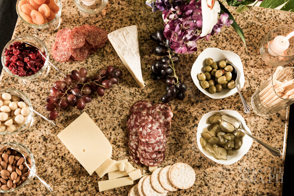 A spread filled with various cheeses and cold cuts on a marble table in the living room