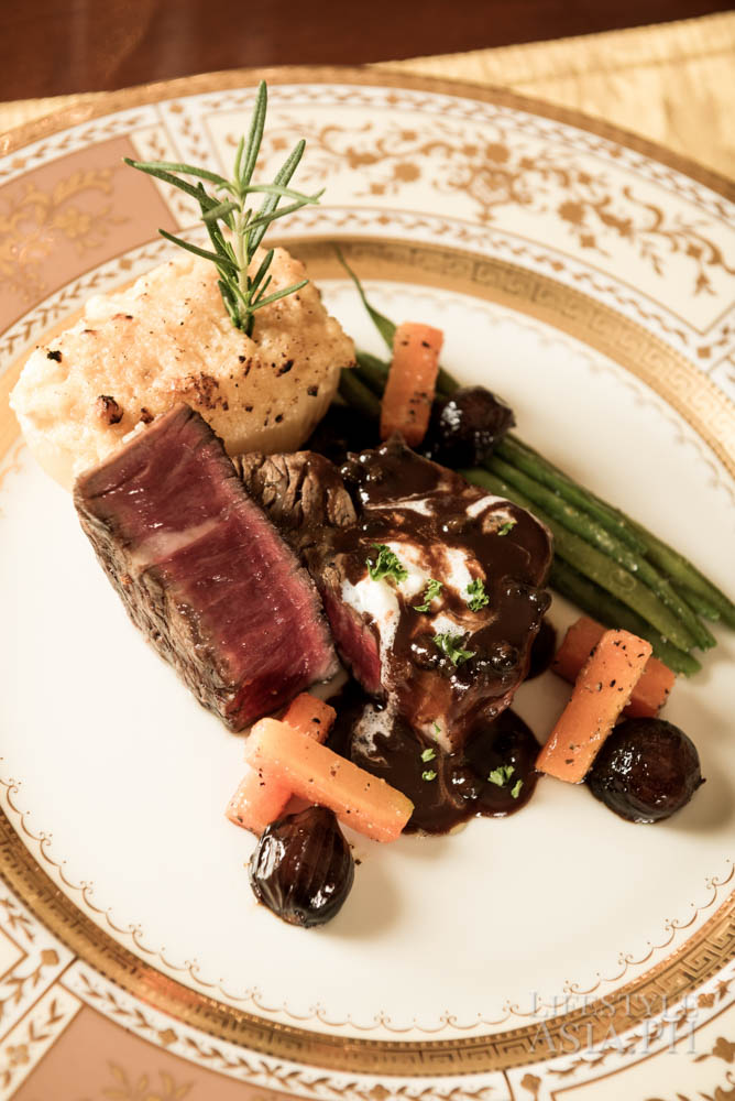 The main course of seared, premium-grade beef with mixed vegetables and potato stack