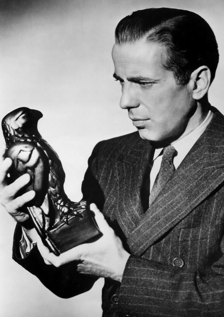 Humphrey Bogart holding The Maltese Falcon (1941) statuette
