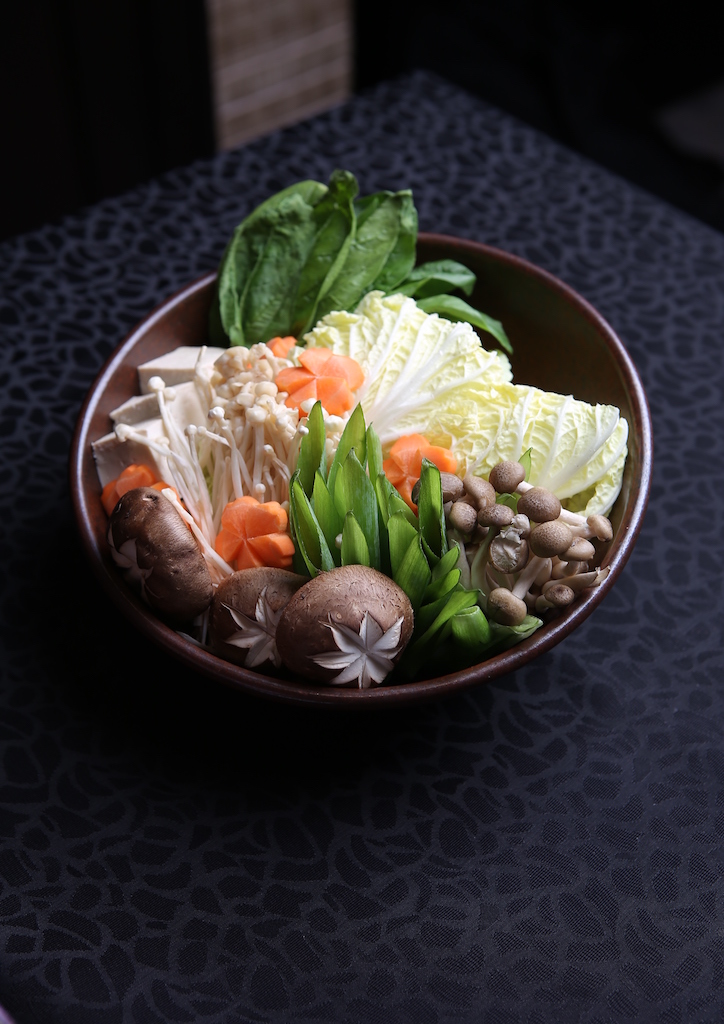 Shabu-shabu hotpot with spinach, tofu, shimeji, cabbage, Enoki mushroom, carrots, and beef slices