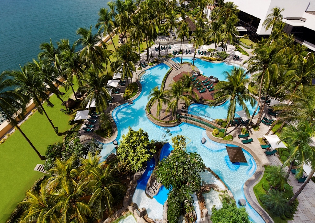 The resort-like pool at Sofitel is designed like a lagoon pool with the water circles around an island of lounge chairs and underneath bridges.