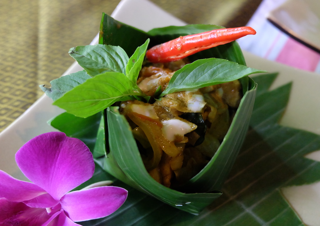Fisk Amok, a traditional Cambodian dish comprised of catfish and a curry-like sauce, finished with a drizzle of coconut milk 