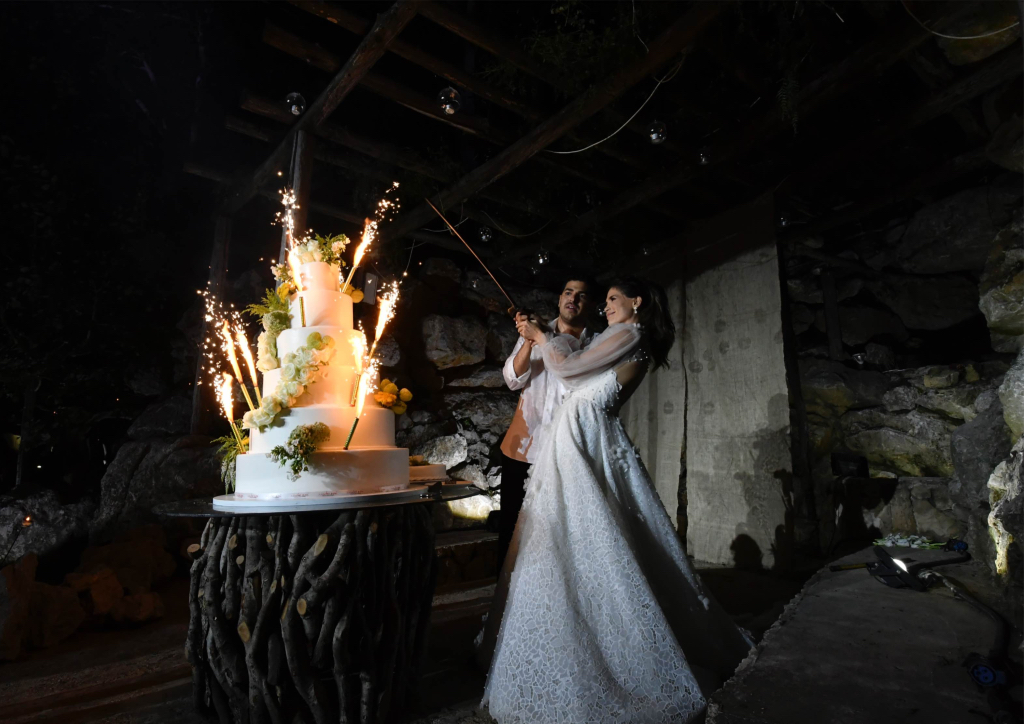 The newlyweds lighting up their cake (Photograph by Bright Light)