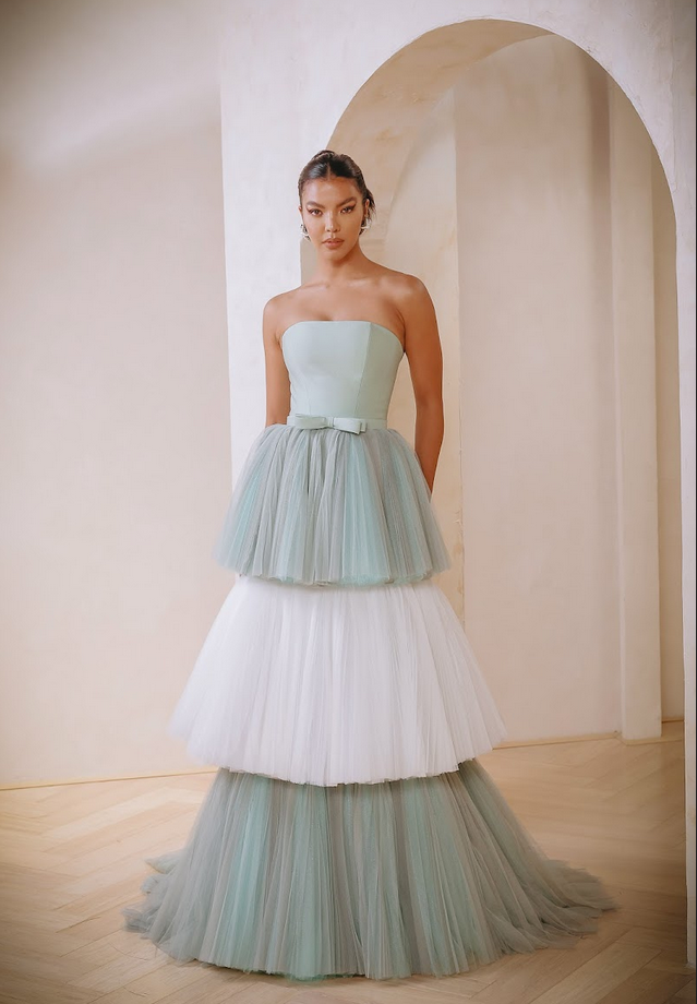 Tulle strapless gown in mint and off white with tiered tulle skirt and bow detail by Mark Bumgarner.